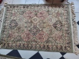 NICE AREA RUG. COLORS ARE OLIVE GREEN, PINK, CREAM ETC. MEASURES APPROX 63 IN LONG AND 39 IN WIDE.