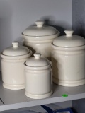 SET OF 4 CREAM COLOR PREFERRED STOCK CERAMIC JARS. IS SOLD AS IS WHERE IS WITH NO GUARANTEES OR