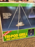 BRAND NEW IN COGHLAN'S BOX TRI-POD GRILL AND LANTERN HANGER. IS SOLD AS IS WHERE IS WITH NO