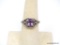 .925 STERLING SILVER & AMETHYST RING. OVAL CUT PRONG SET AMETHYST CENTER STONE, WHICH MEASURES 7.88