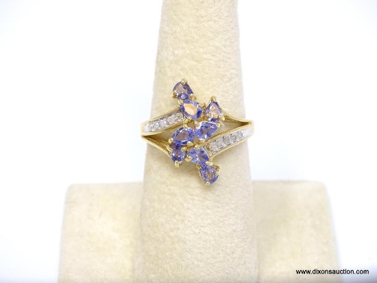 10K YELLOW GOLD TANZANITE & DIAMOND RING. THE RING FEATURES 8 PEAR CUT TANZANITE STONES, WHICH