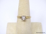 VINTAGE 14K YELLOW GOLD AND DIAMOND RING. APPROX 1/4 CARAT ROUND CUT DIAMOND IN THE CENTER. MARKED