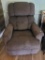 (LR) BROWN UPHOLSTERED MANUAL RECLINER. HAS SOME STAINS.MEASURES APPROX. 31