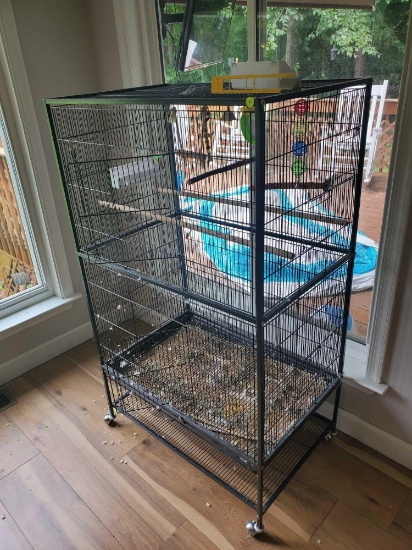 (SUNROOM) LARGE BLACK BIRD CAGE ON CASTERS, 2 DOORS, 1 BOTTOM SHELF MORE INFORMATION.