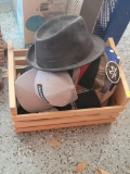 (SHED1) SMALL CRATE LOT OF ASSORTED HATS. MOST APPEAR TO BE BASEBALL CAPS, SOME STILL HAVE TAGS.