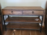 (LR) FARMHOUSE STYLE WOODGRAIN CONSOLE TABLE WITH 2 DRAWERS AND 2 SHELVES. HAS METAL DETAILING ON