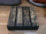 (LR) BENCH MADE WOODEN PLATFORM. STAINED BLACK WITH WEAR ON TOP. MEASURES APPROX. 25 .5 X 24 X 6.