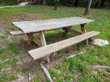 (BY WATER) WOODEN TWO BENCH PICNIC TABLE.