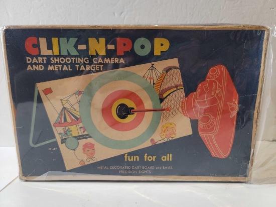 1960'S CLIK-N-POP DART SHOOTING CAMERA AND METAL TARGET. METAL DECORATED DART BOARD AND EASEL