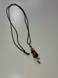 AMBER COLORED AND BLACK GLASS DALEK BEAD/PENDANT ON BLACK ROPE CHAIN. MEASURES APPROX 2