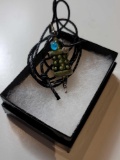 GREEN GLASS DALEK BEAD/PENDANT WITH GRAY, BLACK, AND BLUE TONED ACCENTS ON BLACK ROPE CHAIN.