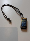 DR. WHO NECKLACE MADE FROM A DOMINO. ONE SIDE HAS TARDIS AND THE OTHER IS 6- 4 OVER 2. PENDANT IS ON