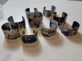 LOT OF (9) ASSORTED DR. WHO THEMED COMIC BOOK BANGLE BRACELETS.