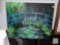 CANVAS PAINTING OF A WALKING BRIDGE OVER POND, MEASUREMENTS ARE APPROXIMATELY 20 IN X 16 IN.