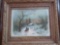 FRAMED PRINT OF A WINTER CABIN, PERSON ON HORSE, MEASUREMENTS ARE APPROXIMATELY 30 IN X 26 IN.