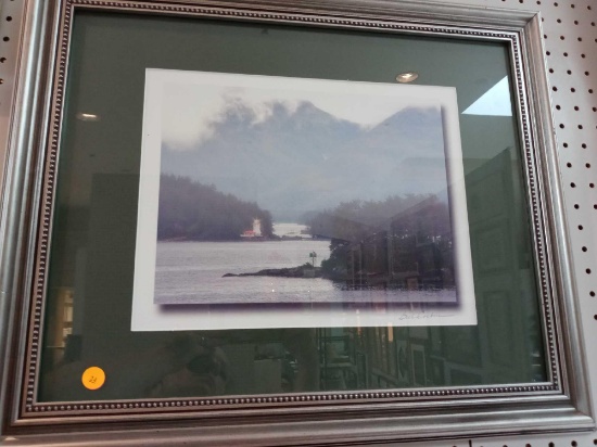 FRAMED PRINT OF RIVER, WOODS, AND A LIGHT HOUSE , MEASUREMENTS ARE APPROXIMATELY 23 IN X 19 IN.