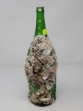 GREEN BOTTLE WITH BARNACLE AND CLAM SHELLS AT 15 INCHES TALL