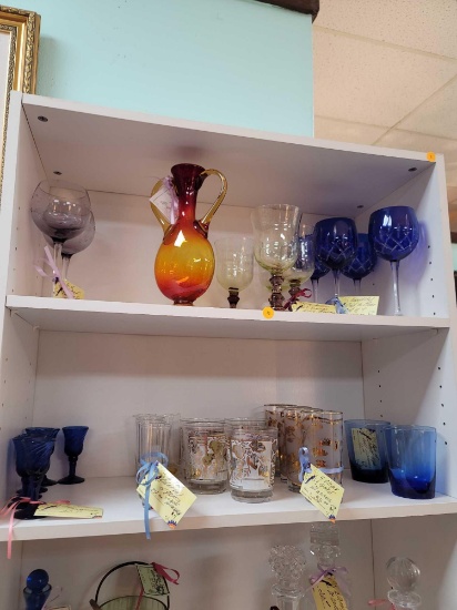 (RM1) TOP 2 SHELVES OF WHITE BOOKCASE. ASSORTED GLASSWARE TO INCLUDE: COBALT BLUE CORDIALS, CLEAR