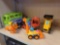 LOT OF ASSORTED TOYS. INCLUDES FISHER PRICE TOY CARS. MELISSA & DOUG WOODEN BACKHOE, A FOX, ZURU