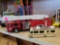 LOT OF 2 TOY TRUCKS. INCLUDES A HESS FIRE TRUCK WITH LIGHTS AND A GREEN LIGHT 1986 FLEETWOOD BOUNDER