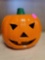 CERAMIC JACK 'O LANTERN. HOLDS A TEALIGHT CANDLE. HAS A BROKEN TOOTH. MEASURES APPROX. 6