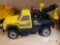 VINTAGE METAL TONKA ROAD SERVICE TOW TRUCK. BLACK AND YELLOW IN COLOR.