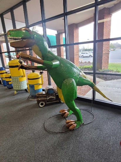 BENCH MADE LARGE OUTDOOR METAL T-REX YARD STATUE. GREEN AND YELLOW WITH BROWN ACCENTS. SITS ON REBAR