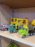 LOT OF 3 TOY CARS. INCLUDES: A FIRE TRUCK, A DRIVEN GREEN TRUCK WITH DUMP BED AND CLAW ARM, AND A