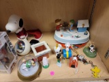SHELF LOT OF ASSORTED PEANUTS AND SNOOPY ITEMS. INCLUDES: ORNAMENTS, A SNOWGLOBE, A DIE CAST CAR, A