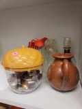 LOT OF ASSORTED ITEMS. INCLUDES: A POTTERY JUG, AN ACORN CANNISTER HALF FILLED WITH COLLECTORS