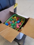 BOX LOT OF GUMBALL MACHINE CAPSULES AND PARTS. MOST APPEAR TO BE ADOPT AN ANIMAL TOYS.