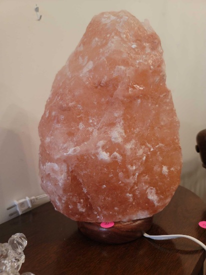 (DR) LARGE LIGHT PINK SALT LAMP. SITS ON ROUND WOOD BASE. MEASURES APPROX 13" TALL. HEAVY.