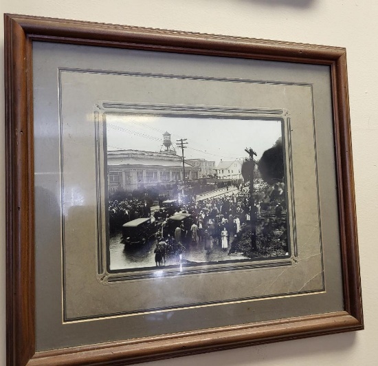 FRAMED BLACK AND WHITE PHOTO OF A BUSTLING STREET SCENE. IS MATTED AND IN A MAHOGANY FRAME. IS SOLD