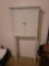 (GAR) MODERN WHITE TWO DOOR OVER THE TOILET CABINET. THE TWO CABINET DOORS OPEN UP WITH SILVED TONED