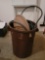 (GAR) HEAVY DUTY BROWN PLASTIC TRASH CAN WITH A LID. ALSO INCLUDES A GARDEN HOSE.