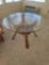 (SUNRM) GLASS TOP WOODEN TABLE WITH WOVEN STRETCHER CENTER. MEASURES APPROX. 47