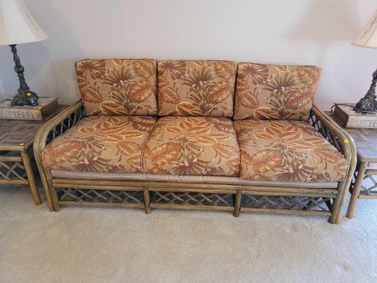 (LR) VINTAGE RATTAN THREE CUSHION SOFA WITH TROPICAL LEAF UPHOLSTERY & WOVEN RATTAN SIDES & BACK. IT