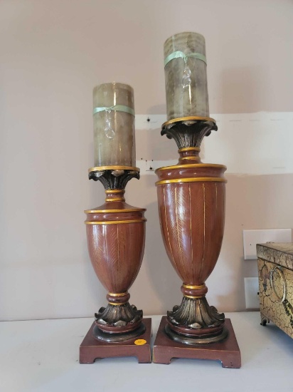 (LR) LOT OF 2 CANDLESTICK HOLDERS. DIFFERENT SIZES BUT BOTH HAVE A WOOD LOOK WITH PAINTED DETAILING.