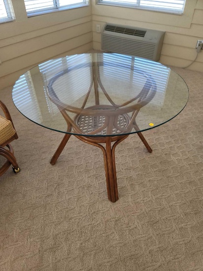 (SUNRM) GLASS TOP WOODEN TABLE WITH WOVEN STRETCHER CENTER. MEASURES APPROX. 47" DIAMETER X 27.5"