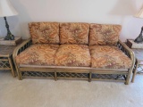 (LR) VINTAGE RATTAN THREE CUSHION SOFA WITH TROPICAL LEAF UPHOLSTERY & WOVEN RATTAN SIDES & BACK. IT