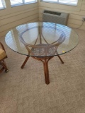 (SUNRM) GLASS TOP WOODEN TABLE WITH WOVEN STRETCHER CENTER. MEASURES APPROX. 47