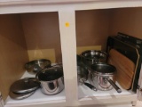 (KIT) CABINET LOT OF ASSORTED POTS AND PANS. INCLUDES: COPPER CLAD POTS, CALPHALON, MARTHA STEWART