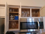 (KIT) 2 CABINET LOT OF ASSORTED GLASSWARE. INCLUDES WINE GLASSES, GIANT SOUP MUGS, DRINKING GLASSES,
