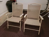 (GAR) SET OF (2) TAN COLORED FOLDING OUTDOOR PATIO ARM CHAIRS. THEY MEASURE APPROX. 25-1/2