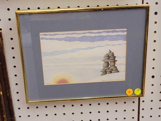 (R1) FRAMED PRINT DEPICTING A STACK OF ROCKS ON A HILL WITH THE SUN BEGINNING TO RISE. MARKED IN THE