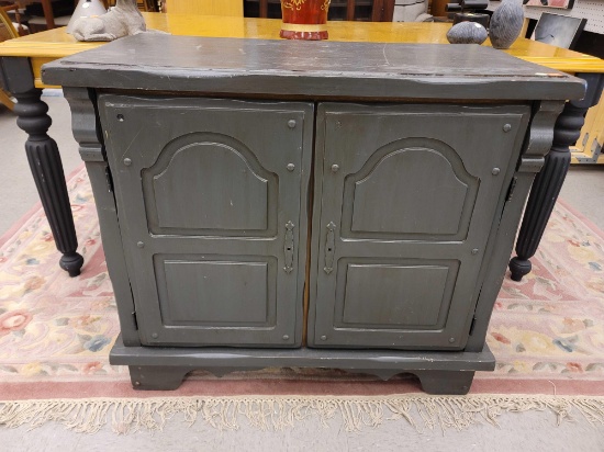 (R1) BLACKISH GRAY PAINTED WOOD TWO DOOR SERVER CABINET. THE TWO DOORS OPEN UP TO REVEAL TWO SLIDE