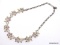 VINTAGE STAR GOLD/SILVER TONE FLORAL PINKISH ORANGE RHINESTONE NECKLACE. MARKED ON THE CLASP. IT