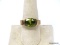 LIA SOPHIA GOLD TONE RING WITH LARGE OVAL CUT PERIDOT GEMSTONE. OPEN GALLERY ON THE TOP AND BOTTOM.