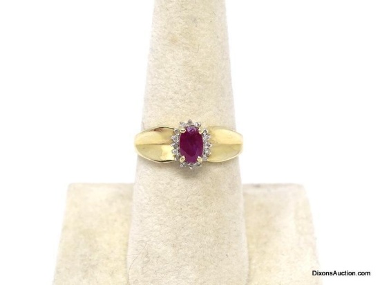 14K YELLOW GOLD RUBY & DIAMOND CHIP RING. OVAL CUT PRONG SET RUBY GEMSTONE BORDERED WITH ROUND CUT
