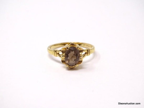 18K YELLOW GOLD H.G.E. SMOKY QUARTZ RING. OVAL SMOKY QUARTZ GEMSTONE IN FLORAL STYLE PRONG SETTING.